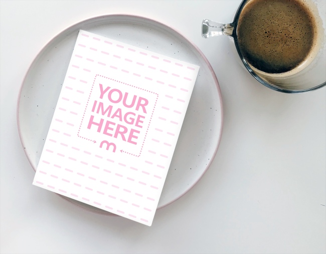 Small Booklet Next to Cup of Coffee on Table Mockup Generator